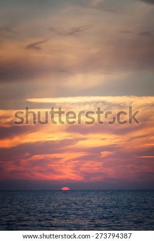 Seascape. The sun falls through the clouds to the sea