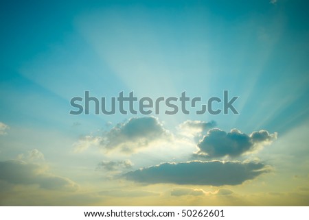 Sunset. Beautiful sun rays scattered clouds.