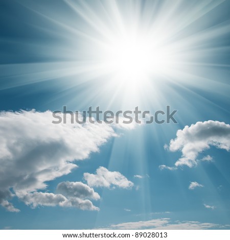 A blue sky with clouds and bright sun