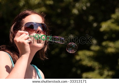 girl makes soap bubbles