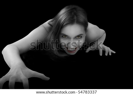 stock photo : Portrait of a female vampire on black background.