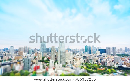 Business and culture concept - panoramic modern city skyline bird eye aerial view from tokyo tower under dramatic grey cloudy sky in Tokyo, Japan. Miniature Tilt-shift effect