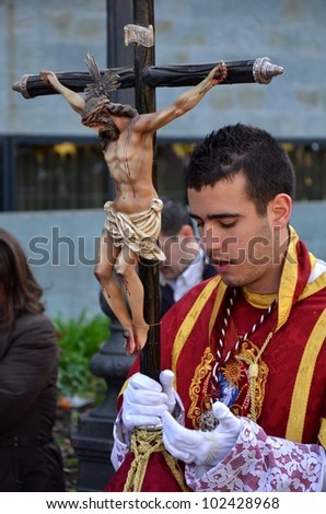 CORDOBA, SPAIN APRIL, 5: Unidentified boy carrying a crucifix in the procession of the Holy Supper. On April 5, 2012 in Cordoba