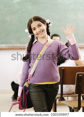 Cute little girl at school saying hello