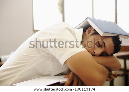Teen student sleeping at classroom