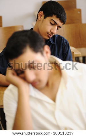 Teen student sleeping at classroom