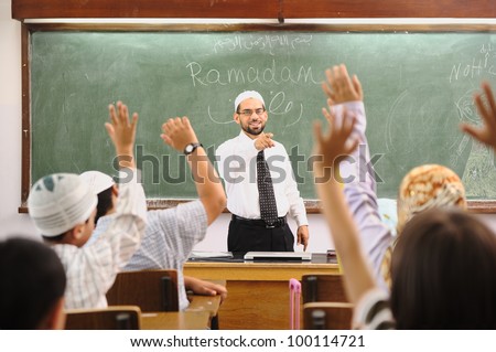 Muslim arabic children with teacher at school
