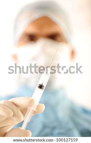 Doctor at hospital holding needle