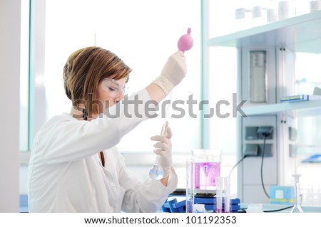 Medical woman measuring liquid in erlenmeyer in lab