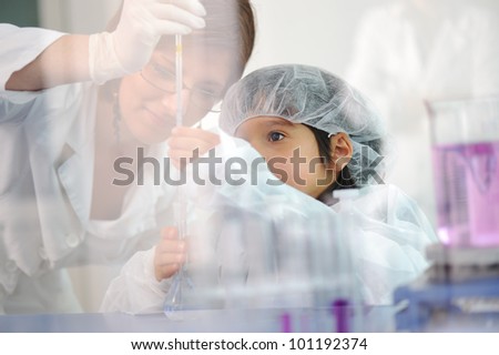 Little boy doing research with senior employee