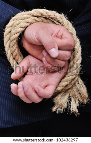 Rope binding man's hands