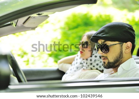 Young couple enjoying in car at fast pace