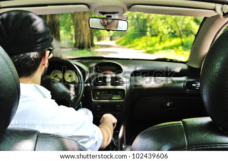 Potrait of a man driving a car without safety belt
