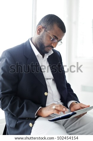 Handsome African American man with tablet computer
