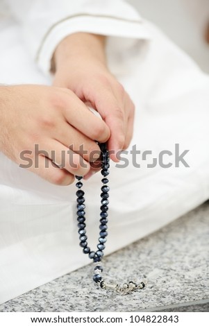 Using rosary beads in hands Using rosary beads in hands