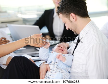 Business people taking care of baby in office