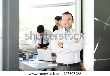 Young businessman portrait and his colleagues working at the back
