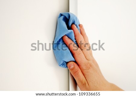 Female hand cleaning surface