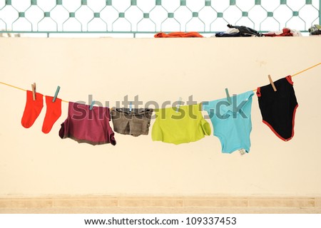 Laundry line with clothes on a sandy backround