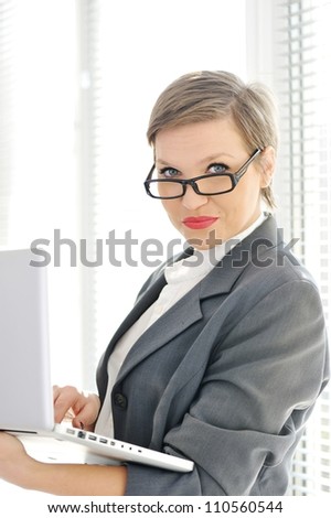 Young business woman at office with laptop