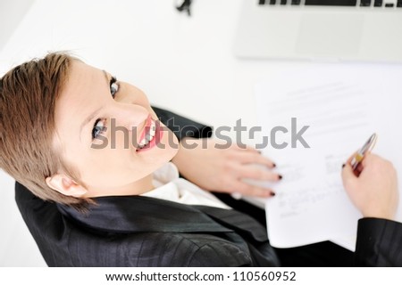 Young business woman signing contract