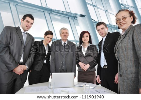 Business people standing around the table in office