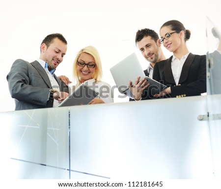 Young business people having conversation using laptops and tablets