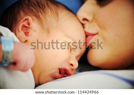 Woman holding her 2 days old newborn baby