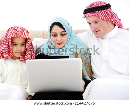 Parents and little boy at home with laptop computer