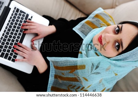 Young woman with laptop on couch