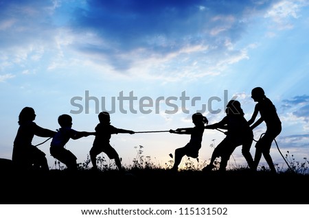 Kids playing tug war pulling rope