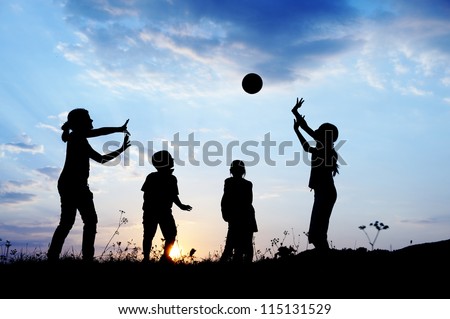 Happy children playing hand ball at sunset time