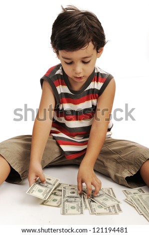 Cute little boy plays with money