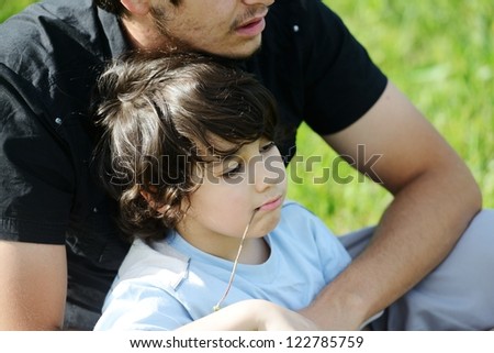 Father and son in nature sitting together