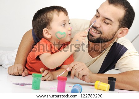 Father and kid playing with paint colors