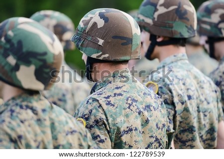 Soldiers with military camouflage uniform in army formation