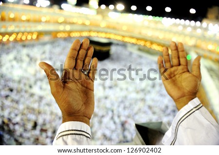 Muslim Arabic man praying at Kaaba in Mecca