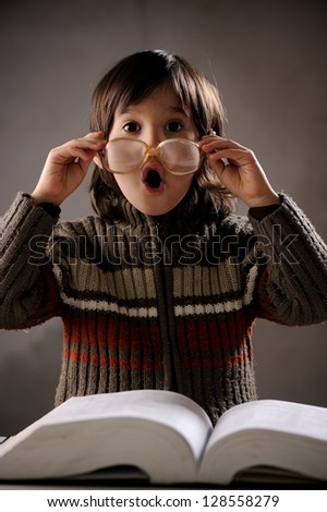 Fine portrait of cute little boy reading book