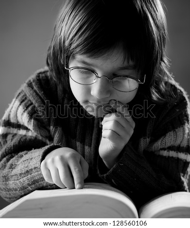 Fine portrait of cute little boy reading book