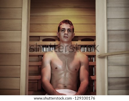 Good looking and attractive young man with muscular body relaxing in sauna hot