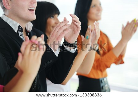 Business people clapping hands during meeting at office or presentation