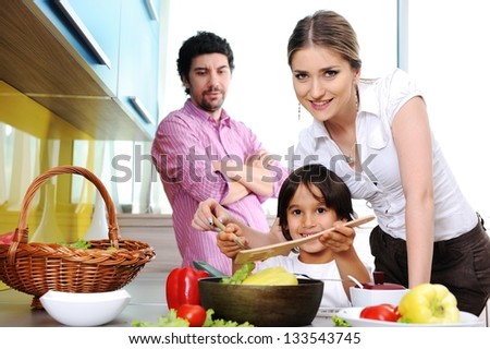 Happy family in the kitchen cooking dinner together