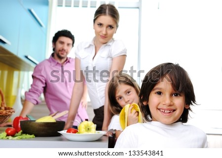 Happy family in the kitchen cooking dinner together