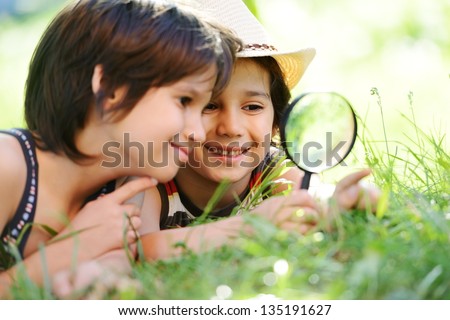 Happy Kid Exploring Nature With Magnifying Glass