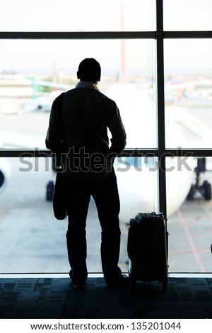 business man carrying a luggage at the airport