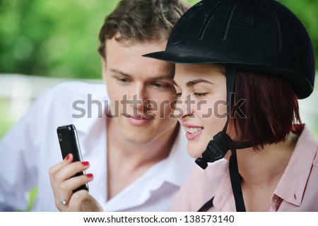 Guy and girl messaging on cell phone