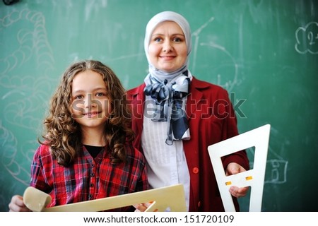 Cute lovely Arabic school children at classroom having education activities