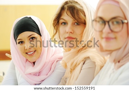 Multi ethnic group of teenage students inside the high school classroom posing on board
