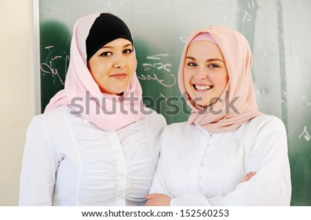 Multi ethnic group of teenage students inside the high school classroom posing on board Multi ethnic group of teenage students inside the high school classroom posing on board