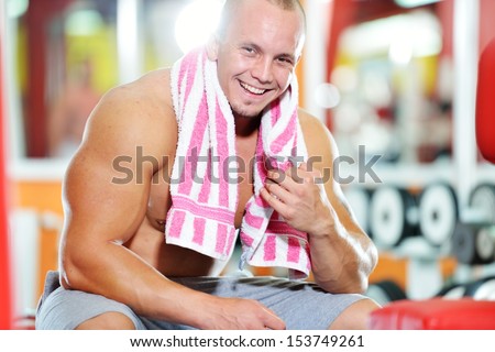 Athletic strong bodybuilder, execute exercise training in sport gym hall